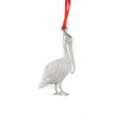 Silver pelican ornament on a white background