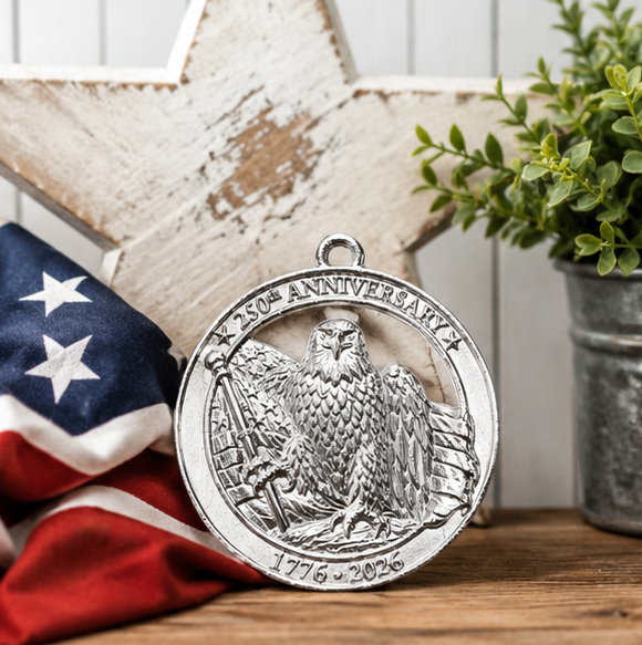 Silver eagle medallion with '250th Anniversary' text, American flag, and plant in the background.