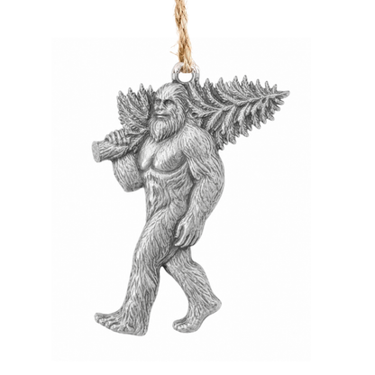 A detailed pewter figurine of a Bigfoot-like creature carrying a pine tree on its back, hanging from a natural jute twine string against a solid white background.