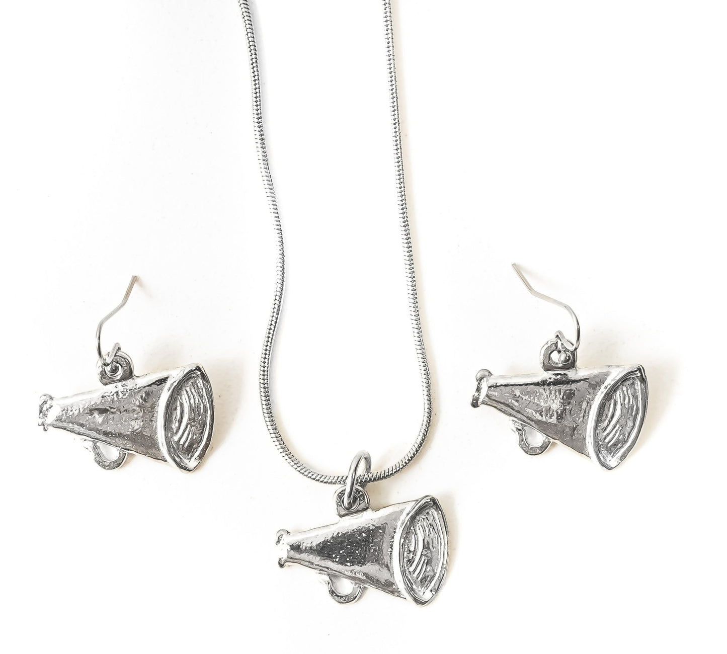 Silver megaphone pendant necklace and earrings on a white background