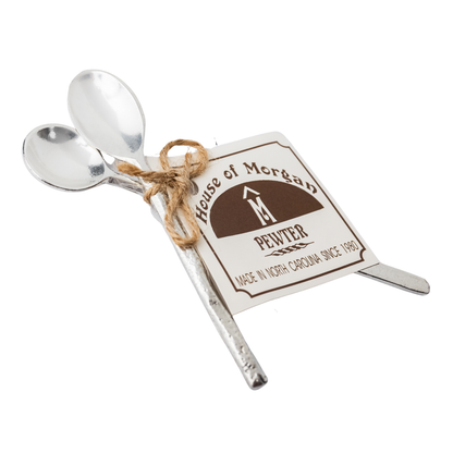 Two silver spoons tied together with a tag reading 'House of Morgan Pewter' on a white background.